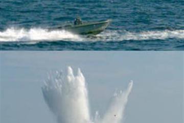Laser-guided smart bomb crushes small boat 